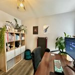 Office with desk, computer, and bookshelf.