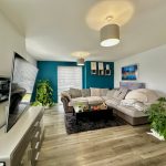 Modern living room with corner sofa and TV.