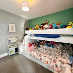 Children's room with bunk bed and toys.