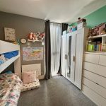 Child's bedroom with bunk bed and wardrobe.