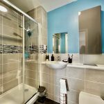 Modern bathroom with shower and sink.