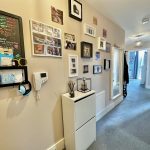 Hallway with pictures and chalkboard on walls