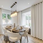 Elegant dining room with modern decor and large windows.
