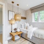 Cosy bedroom with modern decor and window view.