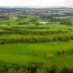 Aerial view of lush green golf course landscape.