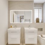 Modern bathroom with twin sinks and mirrored cabinet.