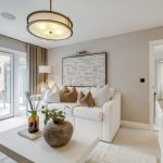 Modern living room with neutral decor and large windows.