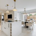 Modern kitchen with island and dining table.