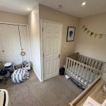 Children's room with cot, drum set, and books.