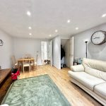 Modern living room with wooden flooring and sofa.
