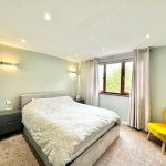 Modern bedroom with grey walls and furniture