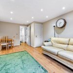 Modern lounge with beige sofa and dining table.