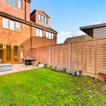Brick house with garden and patio area.