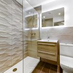 Modern bathroom with shower, sink, and toilet