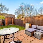 Back garden with patio furniture and shed