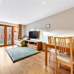 Bright living room with dining area and garden view.