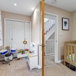 Children's bedroom with cot and toys.