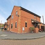 Modern red brick house with car park view