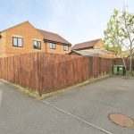 Corner of suburban brick house with driveway