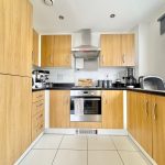 Modern kitchen with wooden cabinets and appliances.