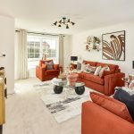 Modern living room with orange sofas and decor.