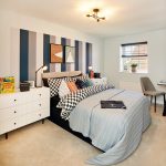 Stylish bedroom with striped wall and modern decor.