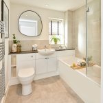 Modern bathroom with sink, mirror, and bathtub.