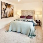 Modern bedroom with abstract art and soft lighting