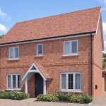 Two-storey brick house with garage and garden.
