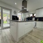 Modern kitchen with island and garden view.