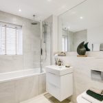 Modern bathroom with shower, sink, and decor.