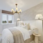 Modern bedroom with elegant decor and neutral tones.