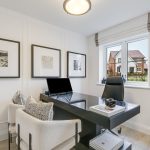 Modern home office with desk and artwork.
