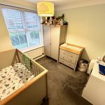 Cosy nursery with cot and changing table.