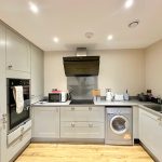 Modern kitchen with appliances and light grey cabinets