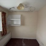 Empty room with mould on the ceiling.