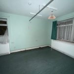 Empty room with green walls and curtains.