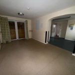 Empty room with sliding doors and archway