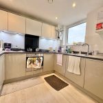 Modern kitchen with appliances, window, and countertops.
