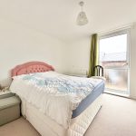 Bright bedroom with bed and large window