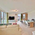 Spacious living room with dining area and television.