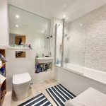 Modern bathroom with shower and toilet.
