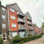 Modern brick apartment building with balconies.