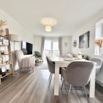 Modern living room with dining area and decor.