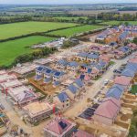 Aerial view of housing estate construction in countryside.