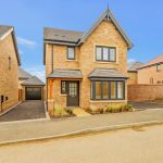 Newly built detached house with driveway and garage.
