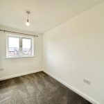 Small empty white room with carpet and window