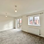 Modern empty room with carpet and balcony view.