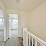 Upstairs landing with open doors to bedrooms.