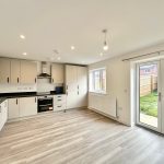 Spacious modern kitchen with garden view doors.